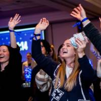 Grads raise hands to catch giveaways